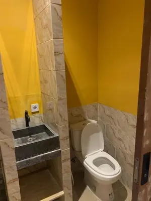 a bathroom with a toilet and a sink at Pradantara House in Nusa Dua
