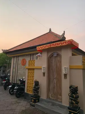 a small house with motorcycles parked in front of it at Pradantara House in Nusa Dua