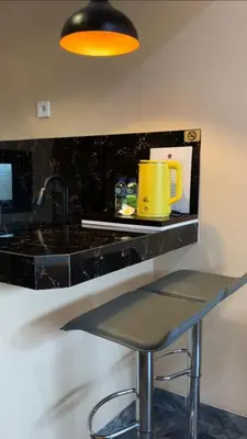 a kitchen with a counter with a yellow mug on it at Pradantara House in Nusa Dua