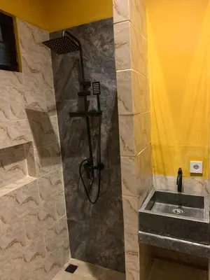 a bathroom with a shower with a sink at Pradantara House in Nusa Dua