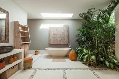 a bathroom with a bath tub and a plant at Chill out in a luxurious 4 BR villa Seminyak in Seminyak