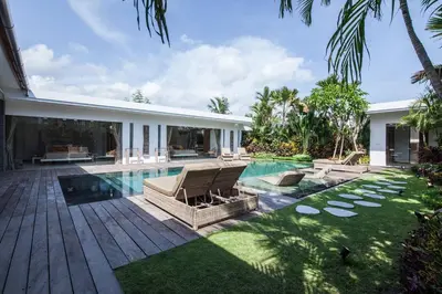 a backyard with a swimming pool and a house at Chill out in a luxurious 4 BR villa Seminyak in Seminyak