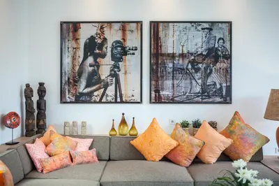 a living room with a couch with colorful pillows at Chill out in a luxurious 4 BR villa Seminyak in Seminyak
