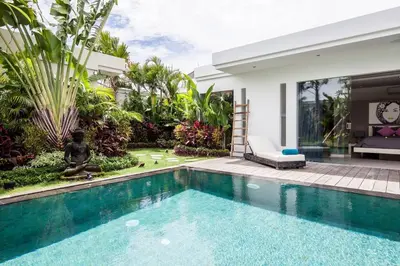 a swimming pool in front of a villa at Seminyak Modern villa 4 BR fully serviced 5 in Seminyak
