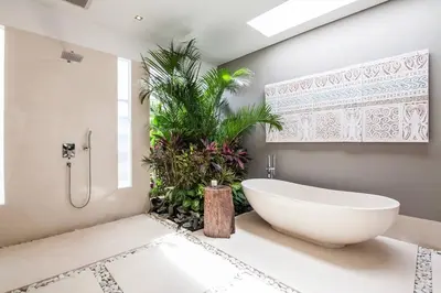 a bathroom with a white tub and a plant at Seminyak Modern villa 4 BR fully serviced 5 in Seminyak