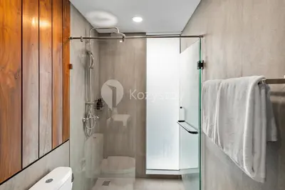 a bathroom with a glass shower and a toilet at Sewana Villa by Kozystay - Natadesa Resort in Jimbaran