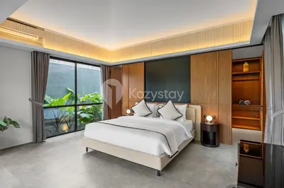 a bedroom with a bed and a large window at Sewana Villa by Kozystay - Natadesa Resort in Jimbaran