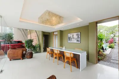 a dining room with a table and chairs at Sans Vibes Astana Residence Seminyak in Seminyak