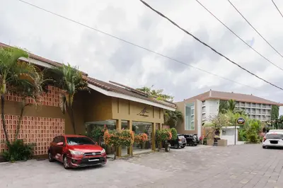 a red car parked in front of a building at Tan's Astana Villa's by The Lavana in Seminyak