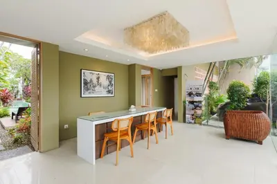 a dining room with a table and chairs at Tan's Astana Villa's by The Lavana in Seminyak