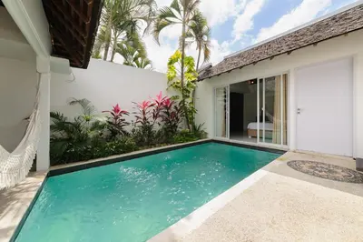 a swimming pool in the backyard of a house at Tan's Astana Villa's by The Lavana in Seminyak