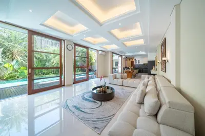 a living room with a couch and a table at Villa Ellyne Canggu by Nagisa Bali in Canggu