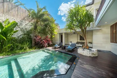 a swimming pool in the backyard of a house at Villa Ellyne Canggu by Nagisa Bali in Canggu