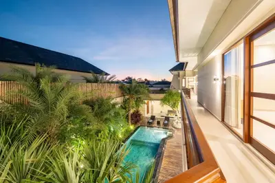 an indoor swimming pool in the middle of a house at Villa Ellyne Canggu by Nagisa Bali in Canggu