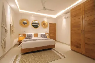 a bedroom with a bed and two mirrors on the wall at NEW 4 BDR Villa Rooftop & pool Seminyak Petitenget in Seminyak