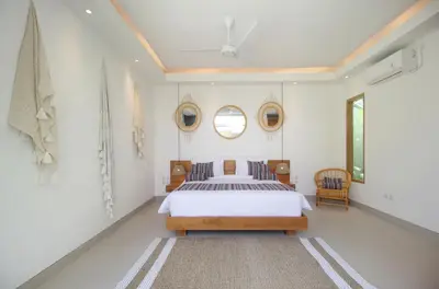 a bedroom with a bed and two mirrors on the wall at NEW 4 BDR Villa Rooftop & pool Seminyak Petitenget in Seminyak