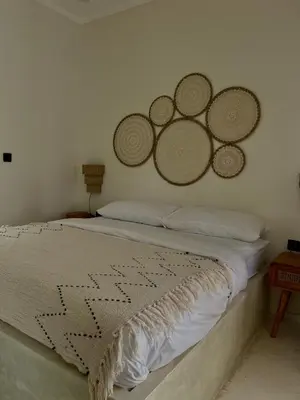a bedroom with a bed with three mirrors on the wall at Shine sunset villa in Kerobokan
