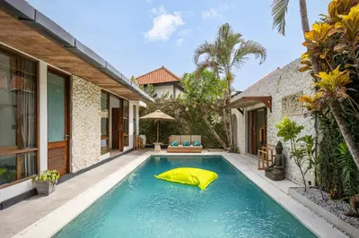 a swimming pool in the backyard of a house at Villa Tropea by BaliSuperHost in Seminyak