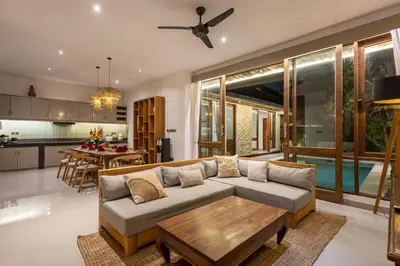a living room with a couch and a table at Villa Tropea by BaliSuperHost in Seminyak