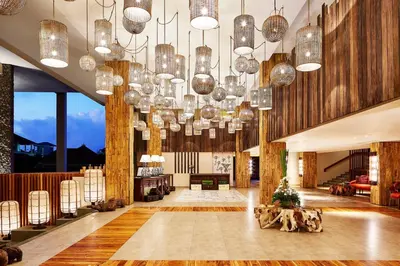 a large lobby with many chandeliers and wooden walls at Four Points by Sheraton Bali, Kuta in Kuta