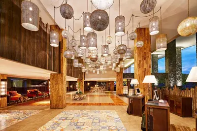 a lobby with many chandeliers in a building at Four Points by Sheraton Bali, Kuta in Kuta