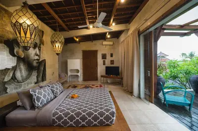a bedroom with a king sized bed in a room at Tropical Villa Batik - Large Garden & Pool, Concierge! 3mins to Beach, Clubs, Cafes in Seminyak