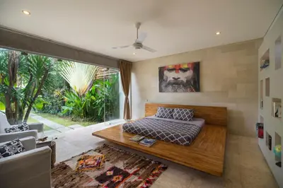 a bedroom with a bed and a large window at Tropical Villa Batik - Large Garden & Pool, Concierge! 3mins to Beach, Clubs, Cafes in Seminyak