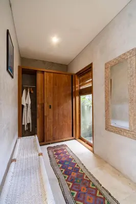 a hallway with a door and a rug at Tropical Villa Batik - Large Garden & Pool, Concierge! 3mins to Beach, Clubs, Cafes in Seminyak