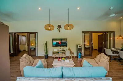 a living room with a couch and a tv at Villa Kiwi Seminyak in Seminyak