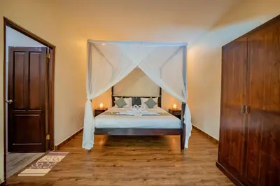 a bedroom with a bed with a canopy at Villa Kiwi Seminyak in Seminyak
