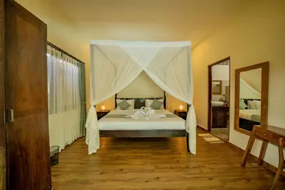 a bedroom with a bed with a canopy at Villa Kiwi Seminyak in Seminyak