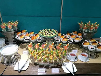 a table with many different types of desserts and cakes at Anathera Resort Kuta Bali Airport in Kuta