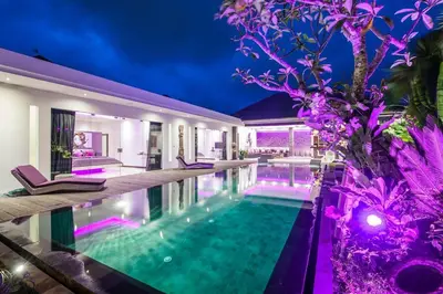 a villa with a swimming pool at night at Seminyak Superbe Villa 4 chambres in Seminyak