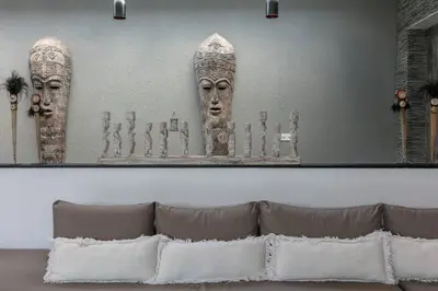 a wall with a picture of two statues on it at Amazing 4 BR villa with garden, pool in Seminyak in Seminyak