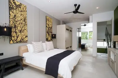 a bedroom with a bed and a ceiling fan at 4BR Group Holiday, Walk to Fitness, Food, Beach in Seminyak