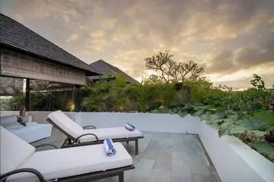 a patio with white couches and chairs on avisor at 4BR Group Holiday, Walk to Fitness, Food, Beach in Seminyak