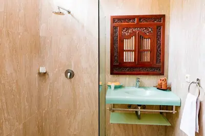 a bathroom with a blue sink and a mirror at Villa Leona Seminyak in Seminyak