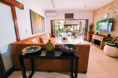 a living room with a couch and a table at Villa Leona Seminyak in Seminyak