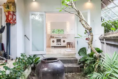 a house with a large vase in the front yard at Villa Bliss Umalas in Kerobokan
