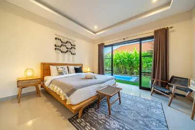 a bedroom with a bed and a large window at New Villa in the best area in Kuta