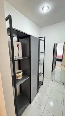 a room with a shelf with a box and a mirror at Ulun Kubu Villa in Kerobokan