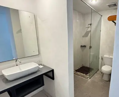 a bathroom with a sink and a glass shower at Ulun Kubu Villa in Kerobokan