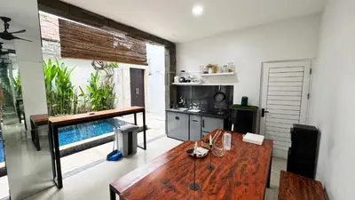 a kitchen with a wooden table in a room at Ulun Kubu Villa in Kerobokan