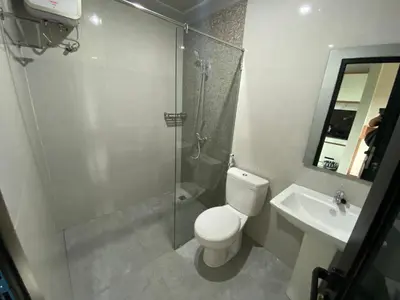 a bathroom with a shower and a toilet and a sink at Semilang House in Ngurah Rai International Airport