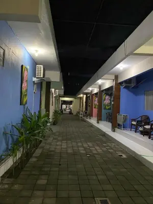 an empty hallway of a hospital with tables and chairs at Cozy room Kuta - 1 minutes to the beach by Micky Studio in Legian