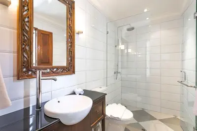 a bathroom with a sink and a mirror and a toilet at Beautiful 1 bedroom villa in perfect location in Seminyak
