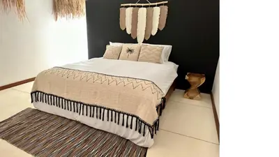 a bedroom with a bed with a chandelier at 2min Beach, Atlas, Finns Canggu in Canggu