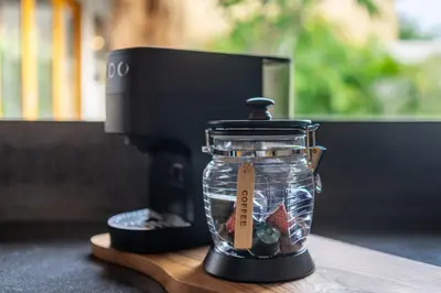 a small glass jar sitting on top of a coffee maker at 2min Beach, Atlas, Finns Canggu in Canggu