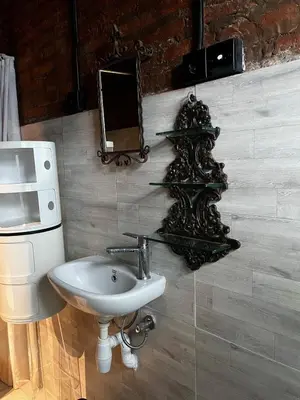 a bathroom with a sink and a mirror on the wall at 1 BR Cozy Apartment in center of Seminyak in Seminyak