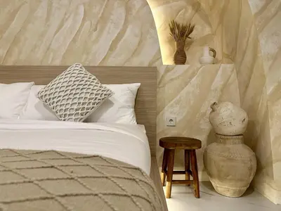 a bedroom with a bed and a table and a vase at Spring Villa Nusa Dua in Nusa Dua